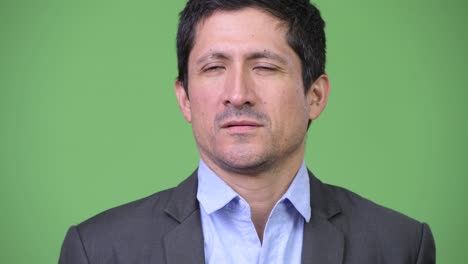 Head shot of Hispanic businessman thinking