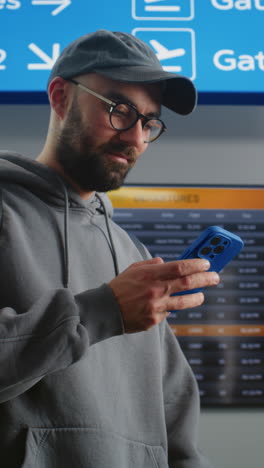 man checking flight information at airport