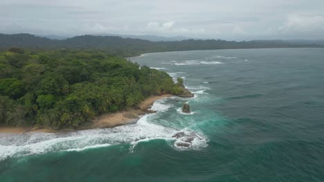 coastal point of manzanillo national nature park with waves breaking on shore