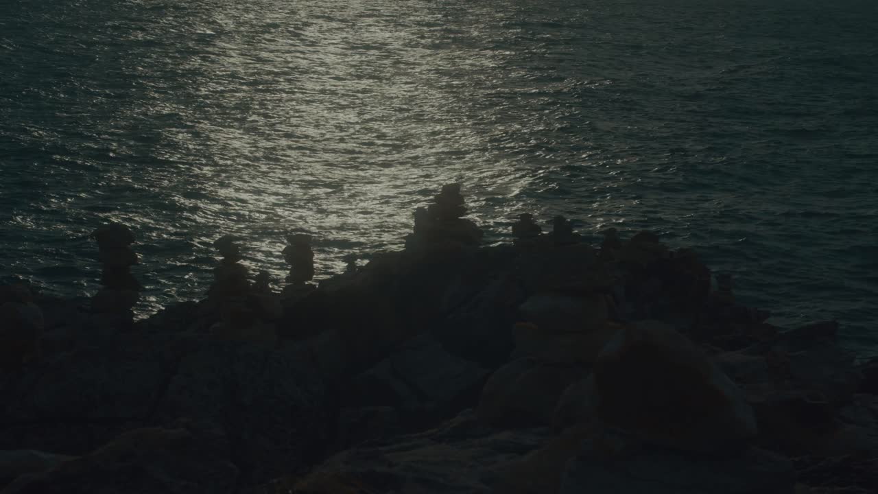Sunset over rocks and stones on the coast
