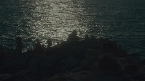 sunset over rocks and stones on the coast
