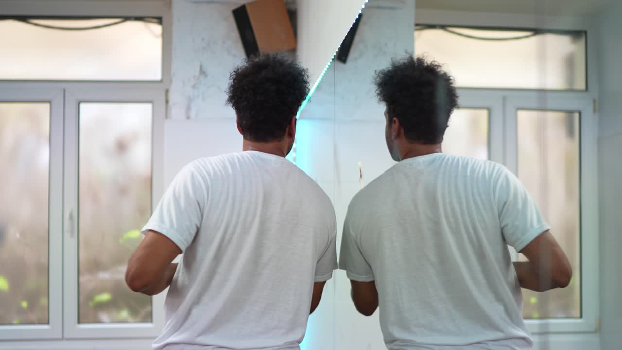 Man Dancing in Front of Mirror