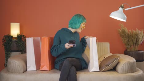 young woman looking at camera with shopping bags.