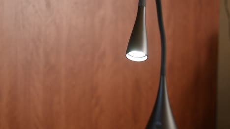 illuminated lit modern minimalist trendy desk lamp close up focus on light bulb