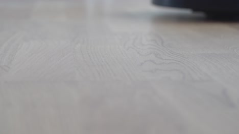 Closeup-shot-of-robot-vacuum-cleaning-surface