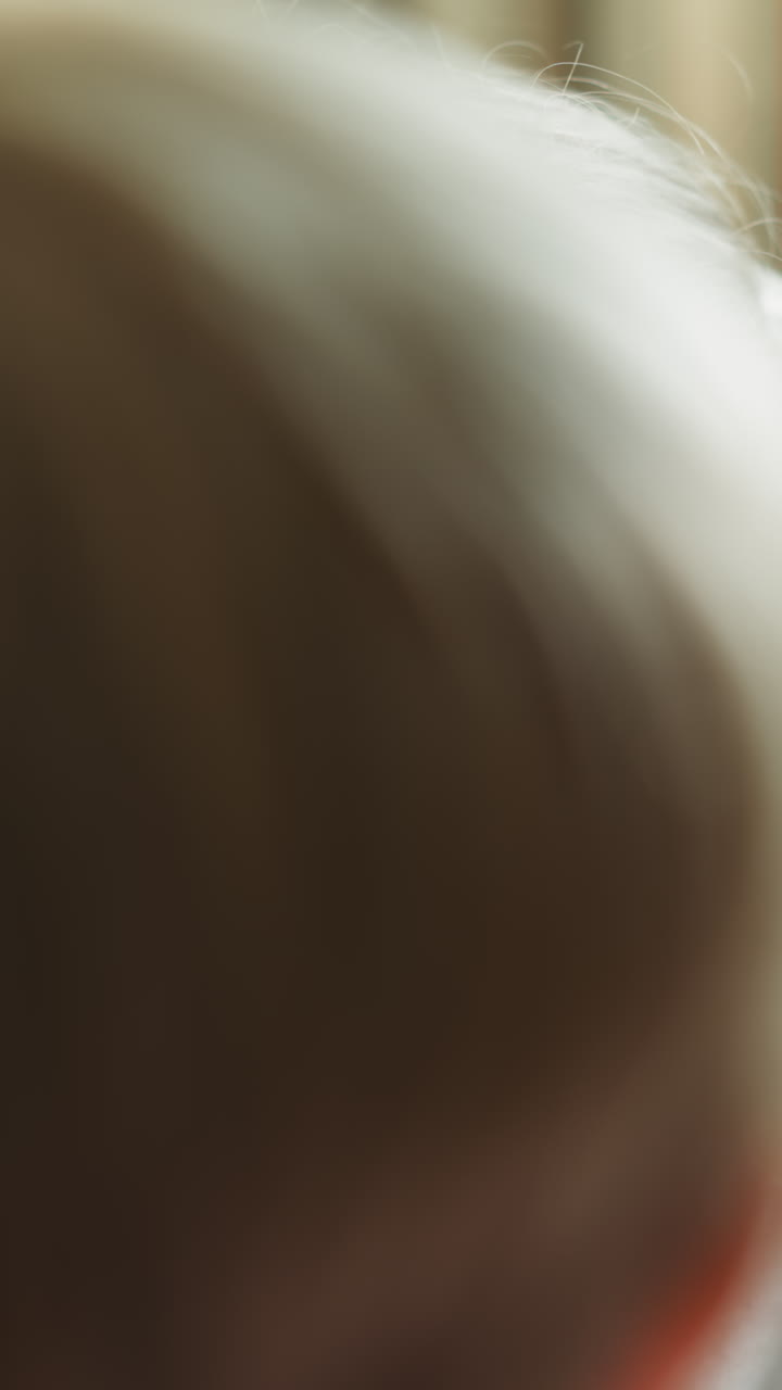 Toddler draws circles around eyes of sister face slow motion. Boy draws red glasses. Couple of children plays with colored pencils at home closeup