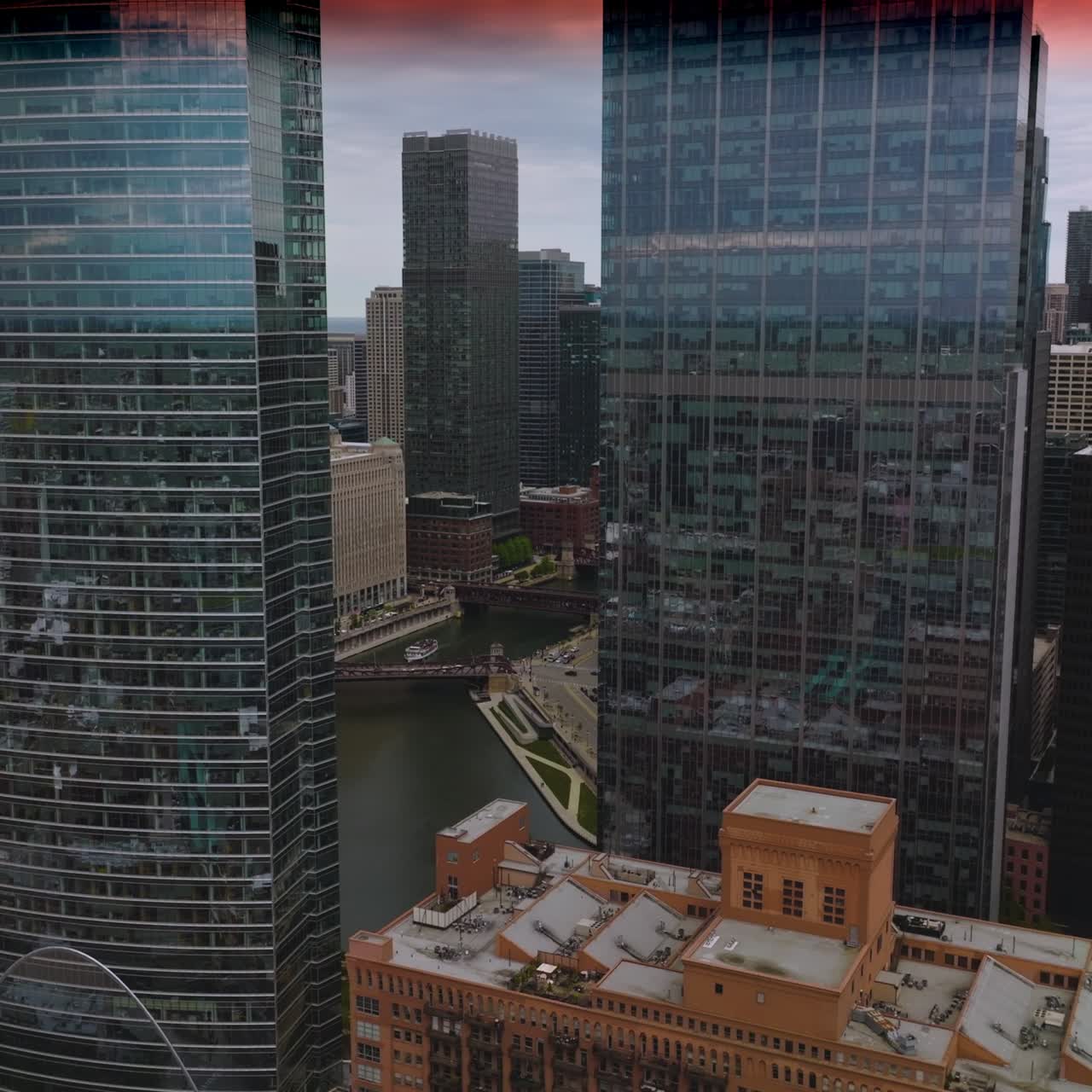 Splendid architecture of Chicago city, Illinois, USA. Stunning view of skyscrapers with mirror windows at the backdrop of pink sky