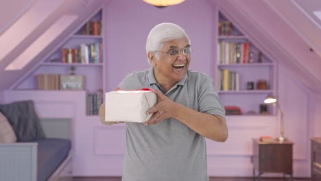 Happy-Indian-old-man-receiving-a-gift