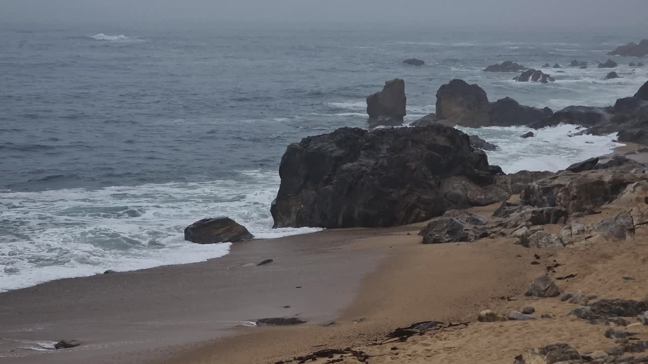 Atlantic Ocean Waves Breaking on Beach and Rocks on Foggy Morning