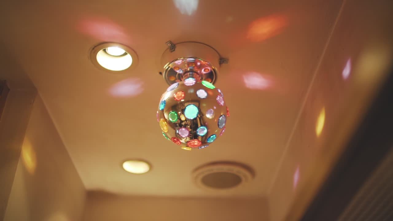 80s Disco Lights With Colorful Reflection On The Ceiling Of A Pub In Tokyo, Japan. Disco Lights Hanging And Spinning And Reflecting Into The Wall. -wide shot