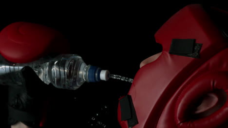 boxer pouring water from bottle into mouth