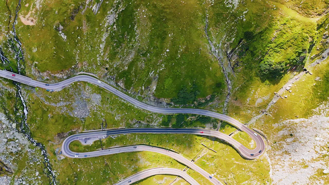 Spectacular Transfagarash Road in the mountainous landscape. Drone footage high above the rocks in Romania