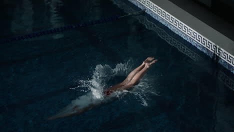 woman swimming freestyle in a pool