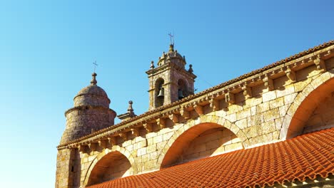 close-up of the church of santa mariña's facade in allariz, showing the detailed stonework and architectural elements.
