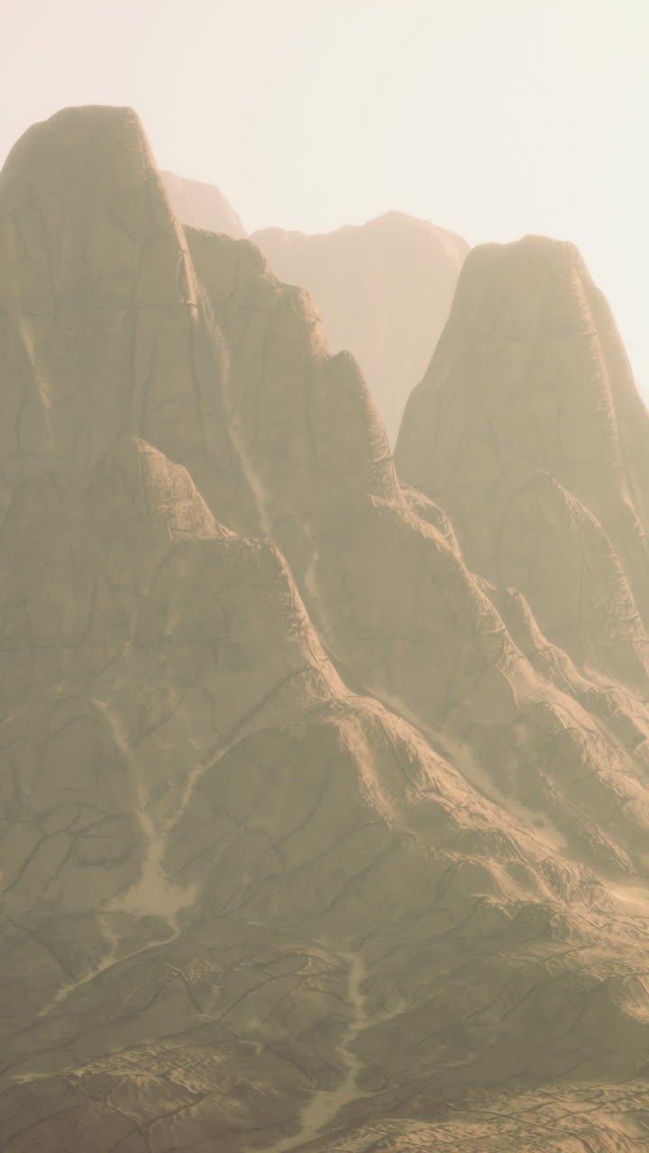 Majestic misty mountains rise under the gentle sunlight in a tranquil landscape