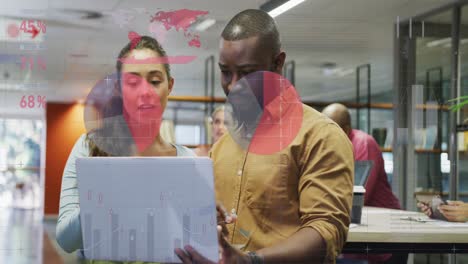 Animation-of-statistical-data-processing-over-diverse-man-and-woman-discussing-over-laptop-at-office