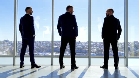successfull handsome businessman silhouettes. businessman shadows near the window.
