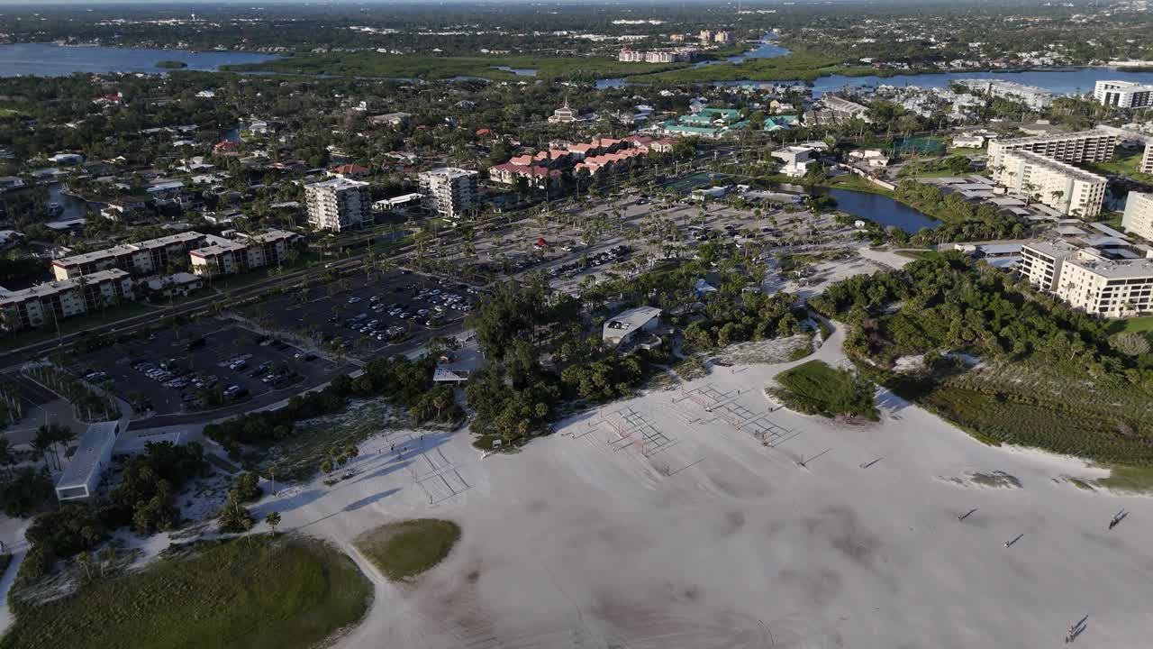 sunseekers sunbathing at Siesta Key island beach near the end of a summer day, Florida