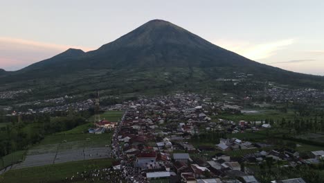 Aerial view, thousands of worshipers praying Eid al-Adha or Eid al-Fitr in Garung Village, Wonosobo. Praying with the most beautiful view of Mount Sumbing and Sindoro.