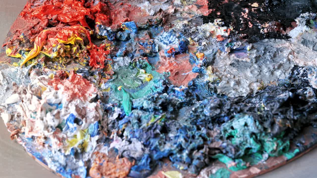 Used palette in a studio with a lot of dry paint on it