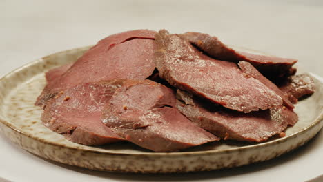 sliced cooked meat on a plate