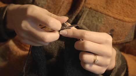 close up female hands knitting - interior