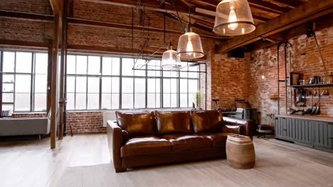 industrial loft living room with leather sofa and brick wall
