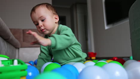 baby playing in a ball pit