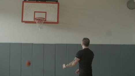 wide of a young man missing a basketball shot