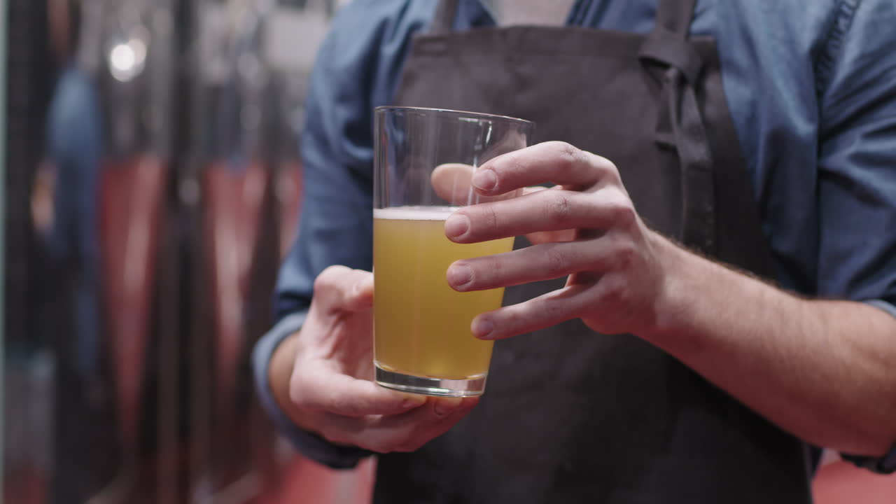 Brewery Worker Holding Freshly Made Beer