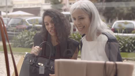 happy female shoppers staring at accessories