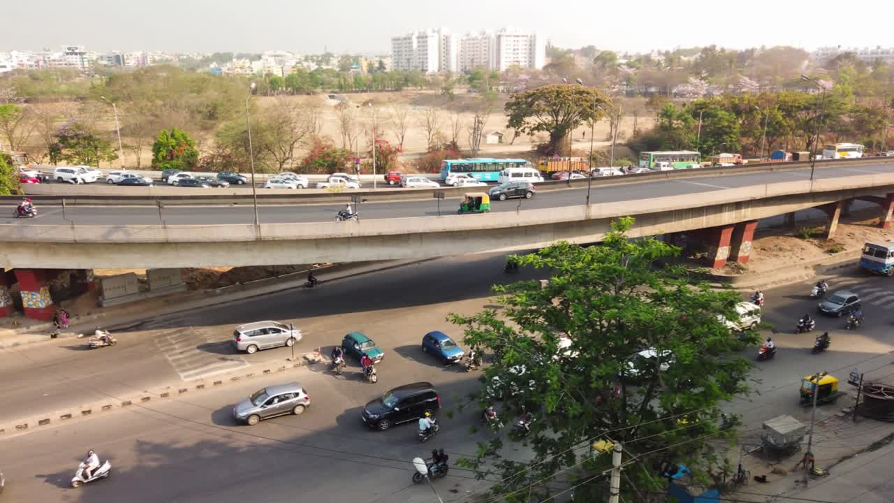 Wide angle panning motion lapse of traffic in KR Puram, Bengaluru, India during early morning hours