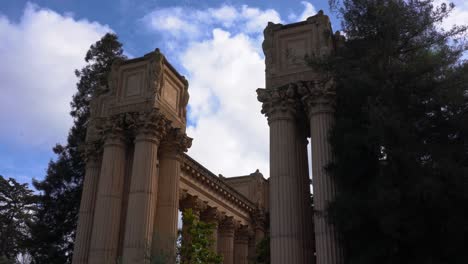 clouds blow over the statues and columns of the palace of fine arts in san francisco