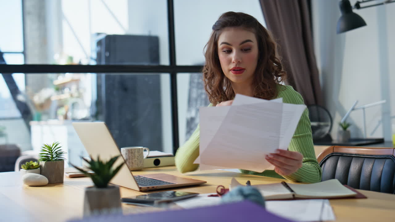Sales manager talking online using laptop office closeup. Woman looking papers
