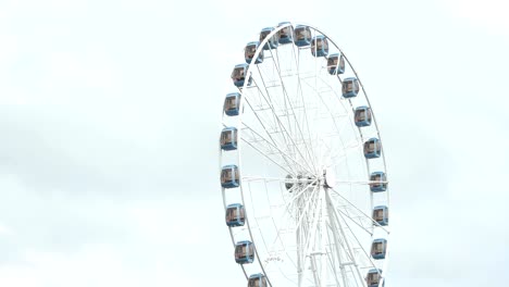 a huge ferris wheel turning around the amusement park