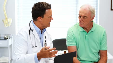 Doctor-interacting-with-senior-patient-over-a-report