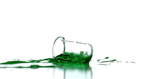 Beaker-falling-and-spilling-green-liquid