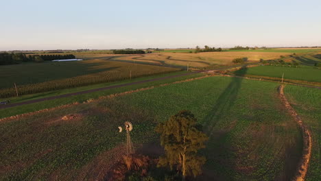 argentinian countryside, aerial view of rural farming landscape on a golden hour sunlight, drone shot