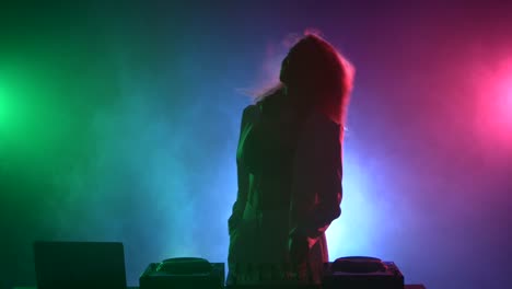 female dj performing in colorful nightclub setting