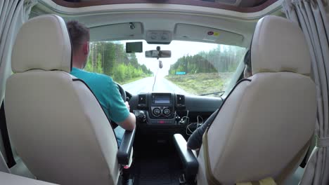 man driving on a road in the camper van rv