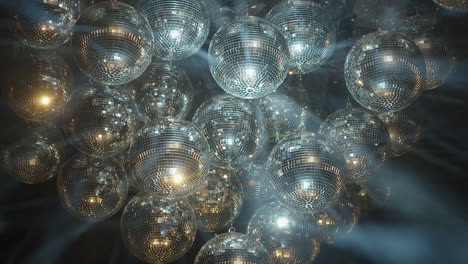 bright spinning mirror balls sparkle light beams in black background