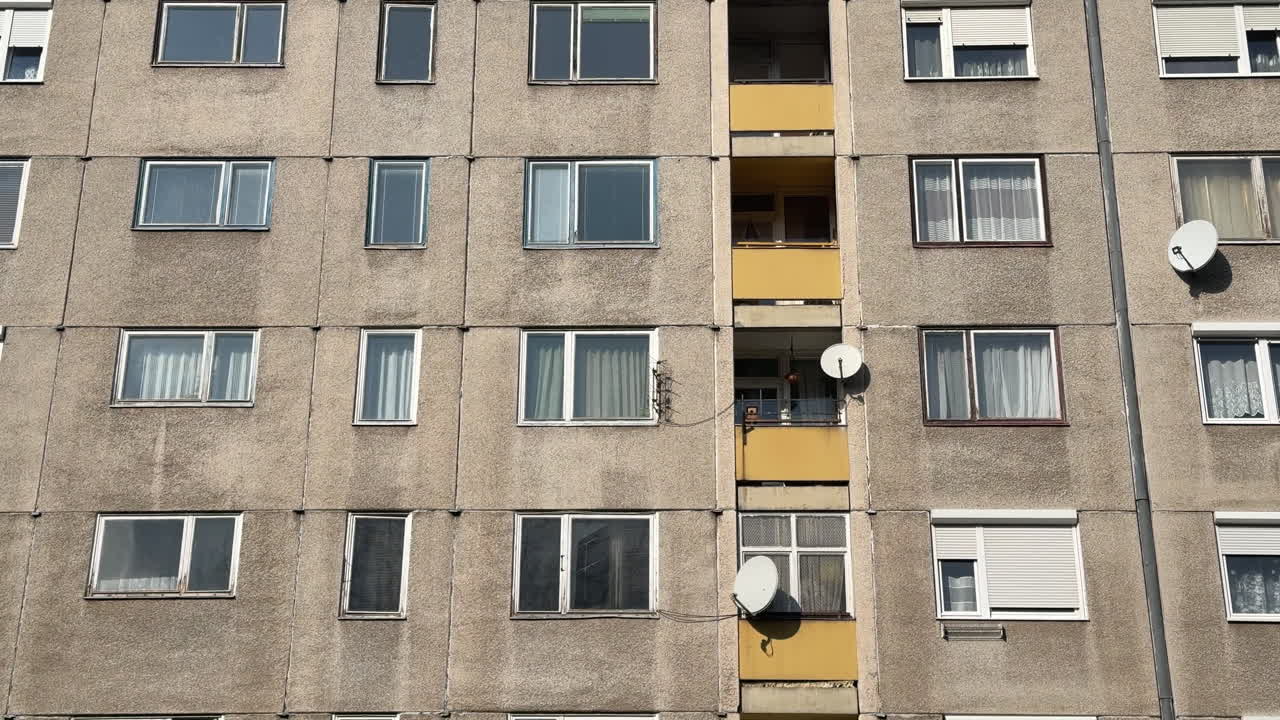 Facade of an old apartment building with satellite dishes