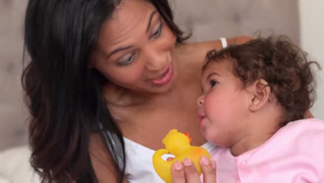 mother with her cute baby playing