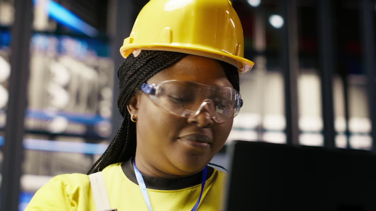 Vertical video Solar panels plant technician uses laptop to oversee systems