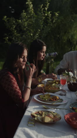 women enjoying an outdoor meal with friends