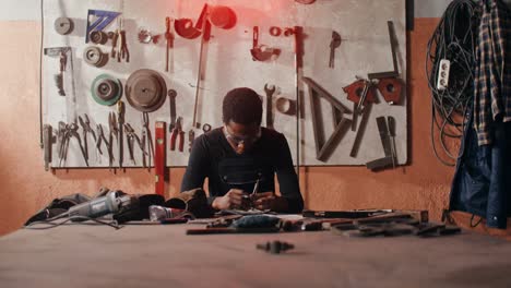 black craftsman working in a metal workshop