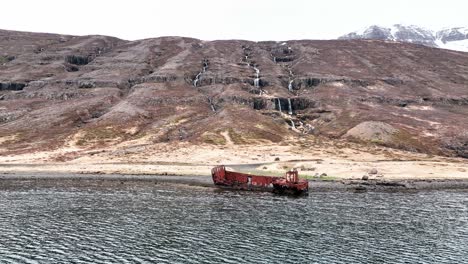 Abandoned-Shipwreck-In-Mjoifjordur,-East-Iceland---aerial-forward