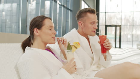 couple relaxing at a spa with cocktails