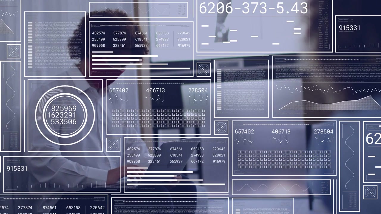 Man typing laptop in hub peer passing starting tech HUD graphs animating over screen updating data