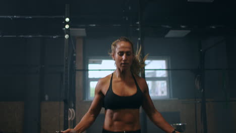 slow motion: skipping woman training at the gym. young woman skipping rope. athlete female jumping on skipping rope at cardio training in gym club.